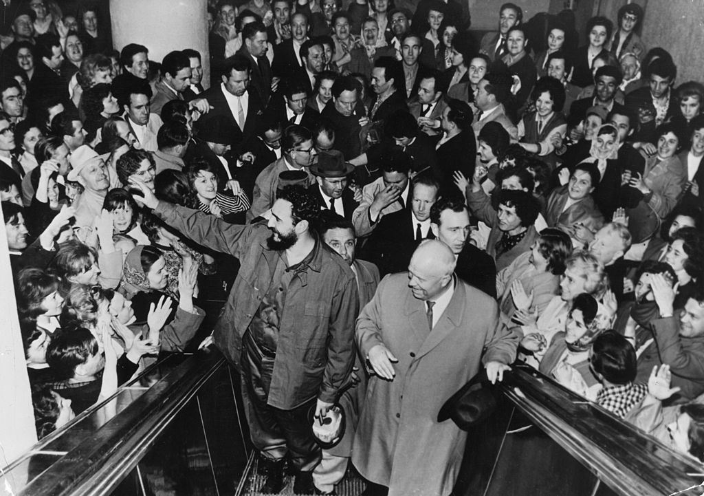 Cuban prime minister Fidel Castro and Soviet leader Nikita Khrushchev going up a moving staircase at Moscow amongst a cheering crowd in 1963 (Keystone / Getty)